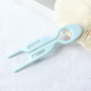 Macro shot of light blue U-shaped hair fork pin with a glossy resin finish and double teeth