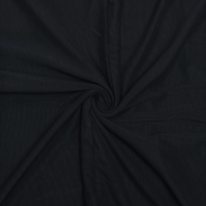 Close-up of black mesh fabric showing elegant ruched texture and drapery of the dress