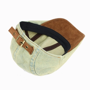 Detail view of denim baseball cap showing suede brim and adjustable leather back strap