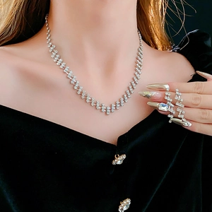 Detail of silver rhodium-plated jewelry set with square rhinestones on fashion model