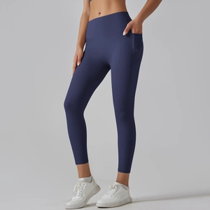 Detail view of high-waisted navy yoga leggings with functional side pockets and soft fabric