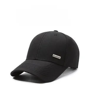 Detail of a black cotton baseball cap with silver Fashion metal plate and stitched brim