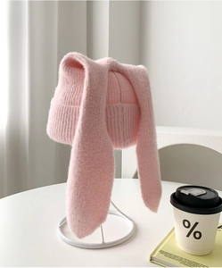 Detailed texture of pink knit bunny ear hat with soft plush material and cute design
