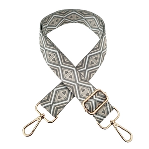 Detail of geometric diamond pattern strap with gold-plated metal swivel snap hooks