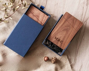 Black walnut wood business card case with custom engraving in a navy blue gift box
