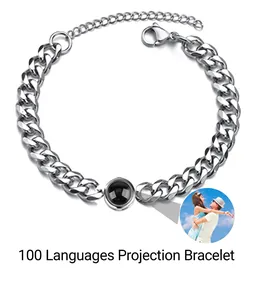 Detail of silver stainless steel Cuban link bracelet with 100 languages projection stone