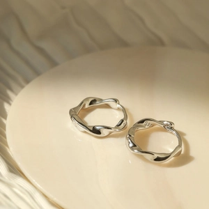Minimalist S925 sterling silver Mobius hoop earrings with twisted texture design