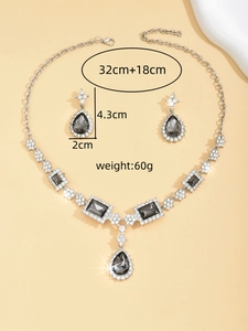 Detail view of silver jewelry set with blue gems and dimensions 32cm necklace 4.3cm earrings