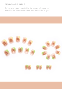 Detail of short squoval press-on nails in brown and yellow tones with rhinestones