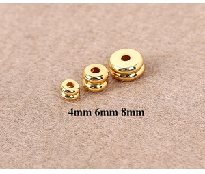 Macro detail of 4mm 6mm and 8mm golden spacer beads for jewelry making