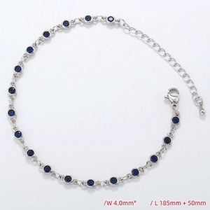 Detailed view of silver chain bracelet with bezel-set blue crystals and lobster clasp