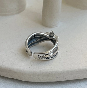 Macro view of vintage 925 sterling silver star ring on minimalist ceramic stand