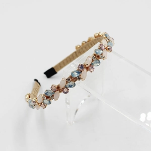 Detail of crystal headband with colorful rhinestones and gold thread weaving