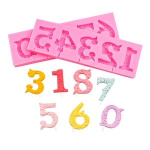Pink silicone 0-9 number molds with colorful textured finished candles on white background