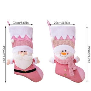 Detailed view of pink Nordic Christmas stockings with 3D Santa and snowman figures