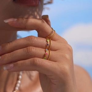 18K gold plated stainless steel rings with colorful enamel accents on model hand