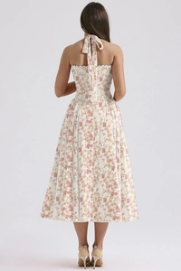 Back view of a white floral halter dress with open back and slim waist for summer
