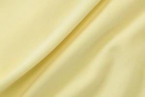 Detailed close-up showing the premium texture and soft folds of the yellow knit fabric