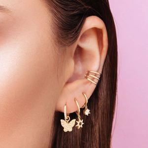 S925 sterling silver tassel earrings with gold butterfly and star pendants on a model