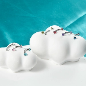Detailed display of colorful zircon curved barbells on creative cloud-shaped stands