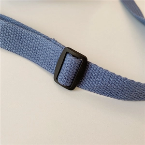 Detail view of the black adjustable buckle and navy blue nylon webbing on the strap