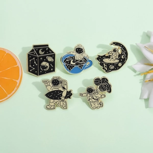 Set of 5 astronaut enamel pins including moon surfing and milk box space themed designs