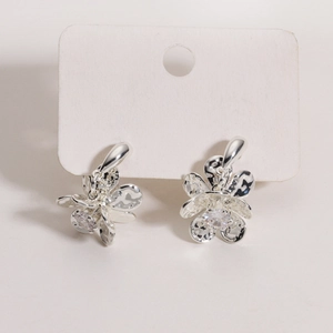 Silver flower stud earrings with brushed metal texture and central sparkling zircon stone