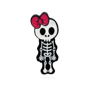 Punk style skull brooch with red bow tie and enamel finish on a white background