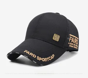 Detail of black baseball cap featuring gold letter embroidery and a square metal plaque