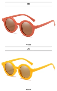 Detail view showing orange and yellow round frame kids sunglasses from a 45-degree angle