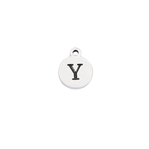 Macro shot of silver stainless steel round pendant with engraved black letter Y detail