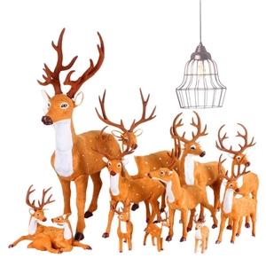 Lifelike artificial Christmas reindeer figurines set in various poses and sizes