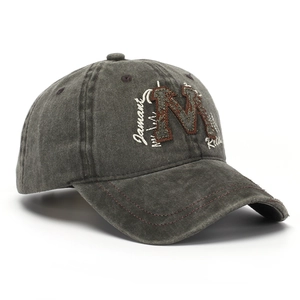 Close-up of vintage dark grey washed cotton baseball cap with M letter embroidery
