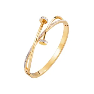 Elegant gold titanium steel nail bracelet with sparkling crystals on a white background