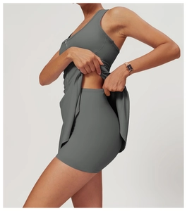 Detail view of dark grey tennis dress with zipper neckline and built-in safety shorts