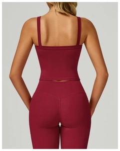 Detail view of burgundy yoga set featuring dual strap back and high waist leggings