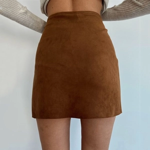 Rear view of brown faux suede A-line mini skirt with single-breasted button detail