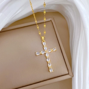 Elegant gold titanium steel cross necklace with sparkling teardrop zircons on a gift box