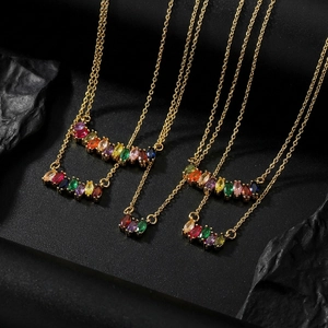 Macro shot of colorful marquise-cut zircon stones on a refined gold chain necklace