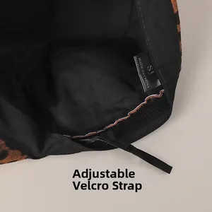 Detail of leopard print hat interior featuring adjustable velcro strap and wash label