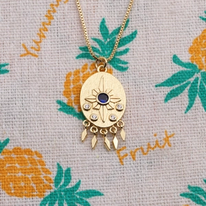 Gold plated evil eye coin necklace with blue zircon pendant and sunburst details