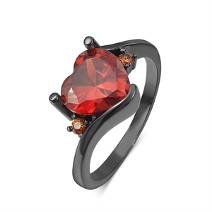 Macro view of heart-shaped red gemstone ring with black band in 45-degree angle
