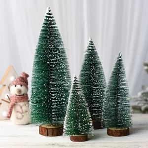 Detail of four mini cedar Christmas trees with snow effect and natural wood bases