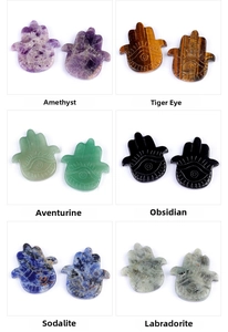 Grid view of carved natural crystal Hamsa Hands in amethyst, tiger eye, and various gemstones