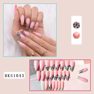 Detail of pink coffin nails with black butterfly patterns and gold glitter french tips