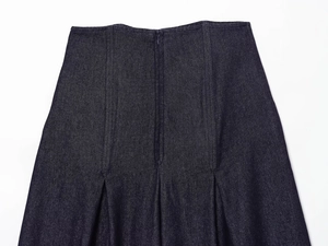 Detail view of high waist denim jeans featuring stitching and zipper on dark blue fabric