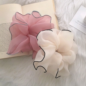 French style contrast mesh scrunchies in pink and cream on a decorative background
