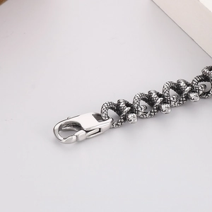 Close-up of vintage steel snake scale texture on men's bracelet with lobster clasp