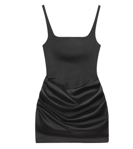 Detail of black mini dress featuring a corset-style bodice and ruched skirt design