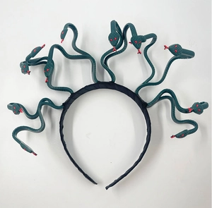 Detail of Medusa headpiece with dark green snakes and red eyes for cosplay